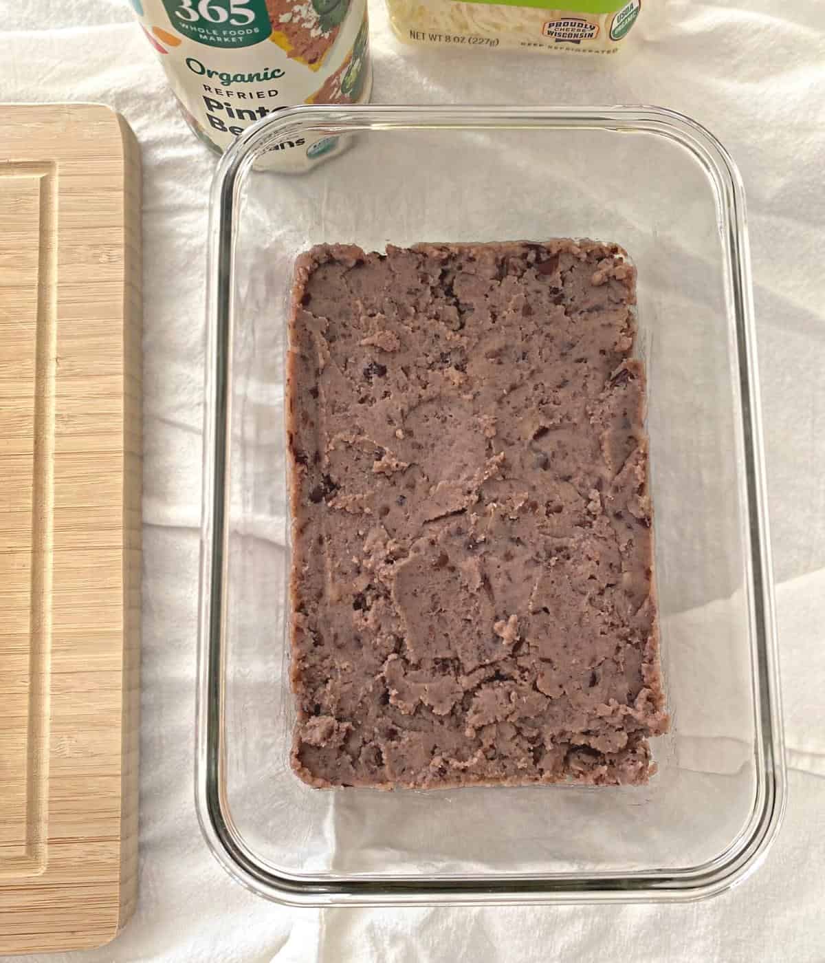 Refried black beans in a glass pan