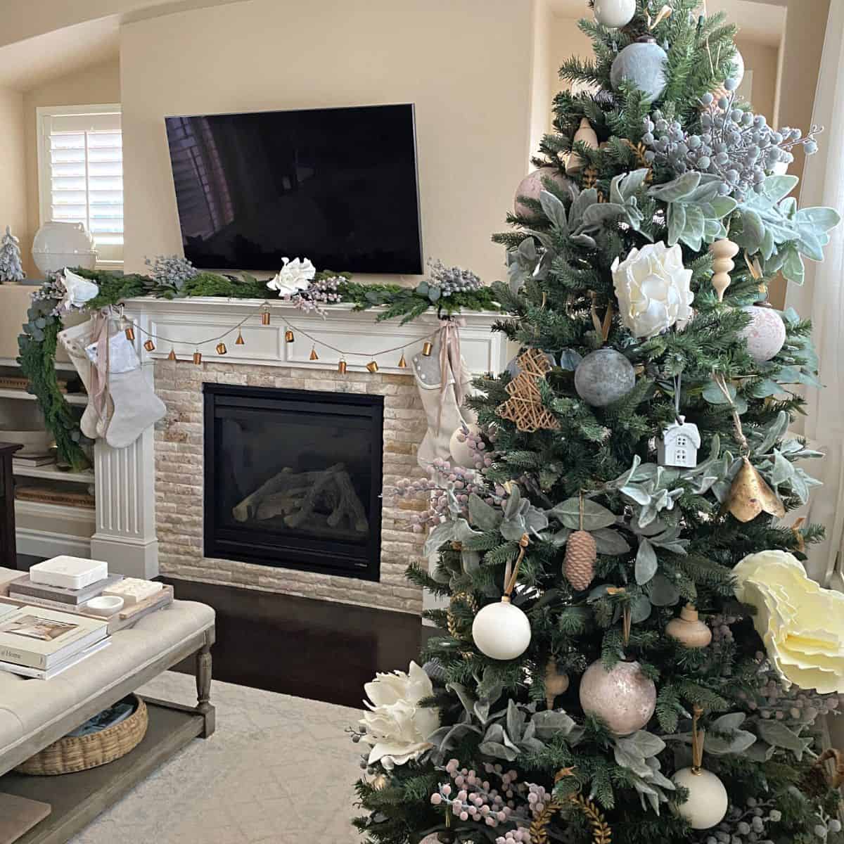 Decorated Christmas tree in living room with fireplace