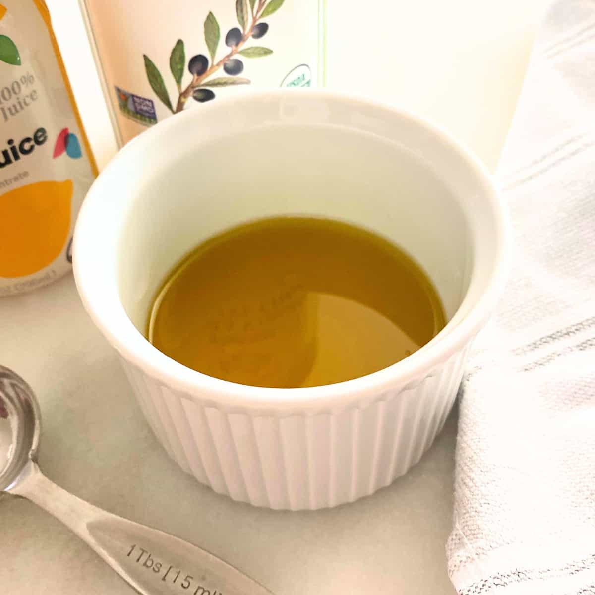 lemon olive oil dressing in white porcelain soufflé dish