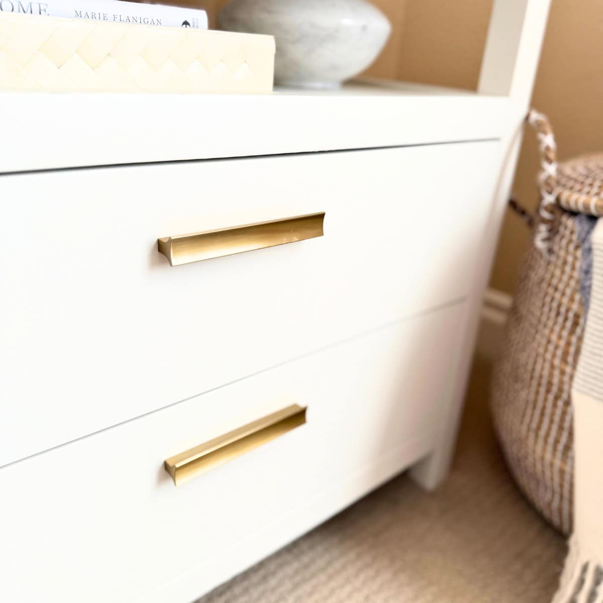 brass pulls on white nightstand