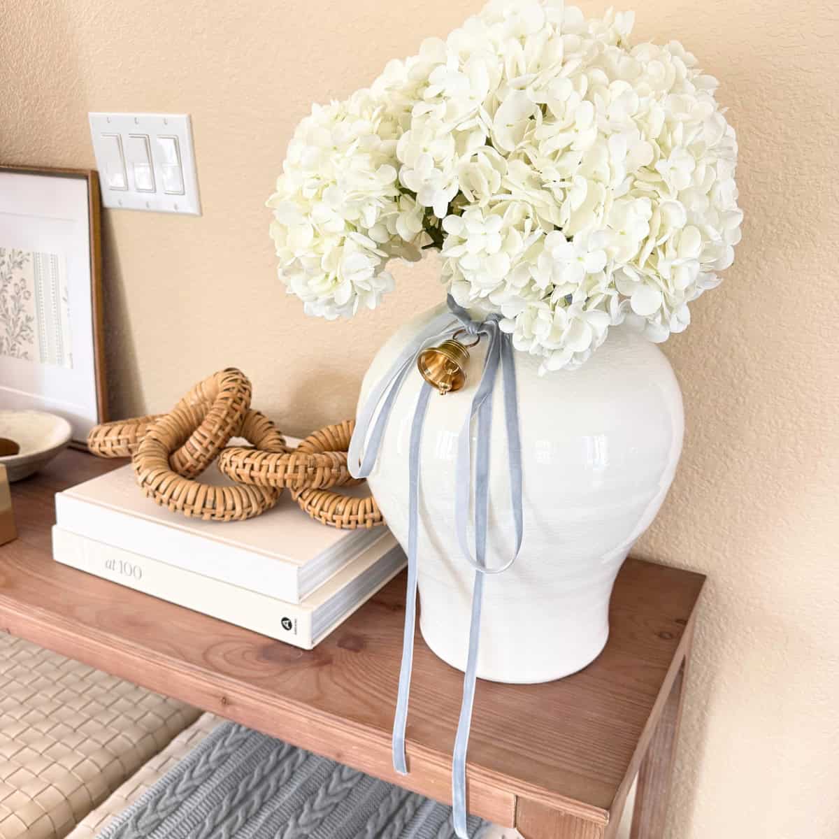 vase with ribbon and a bell tied to it