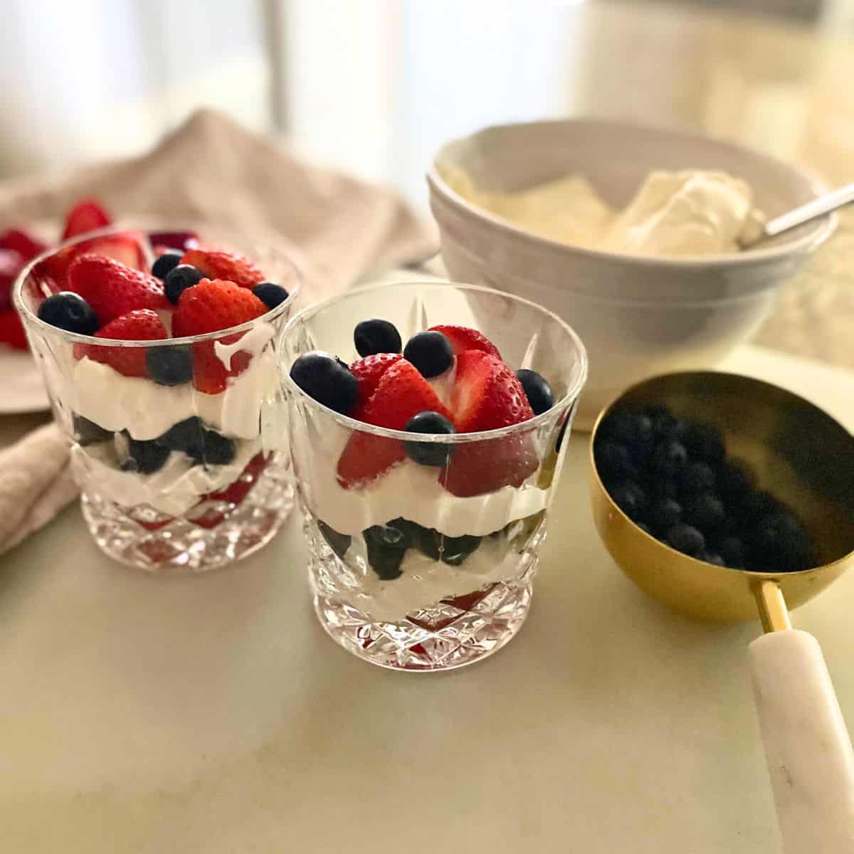 berries and cream in double old-fashioned glasses