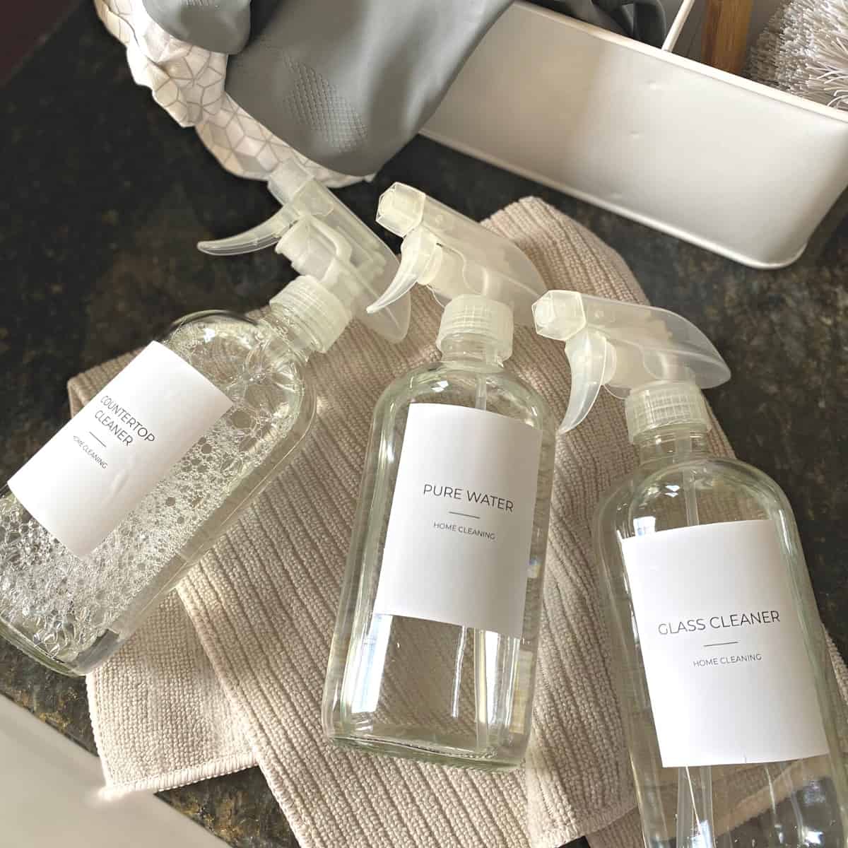Bathroom cleaning products in glass spray bottles from above on cleaning towel