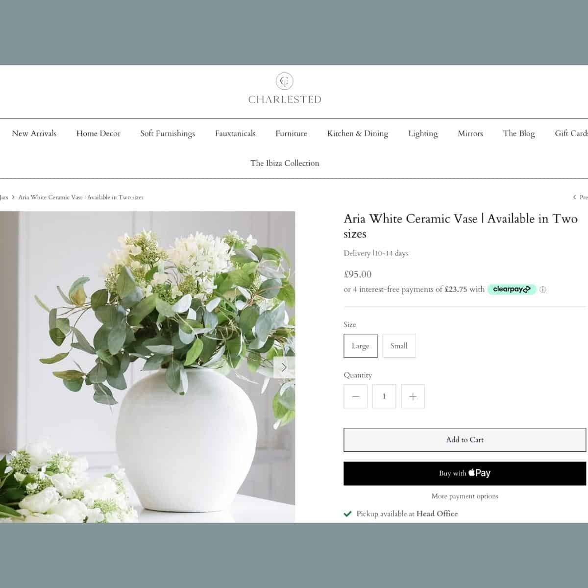 Oversized white vase with faux greenery