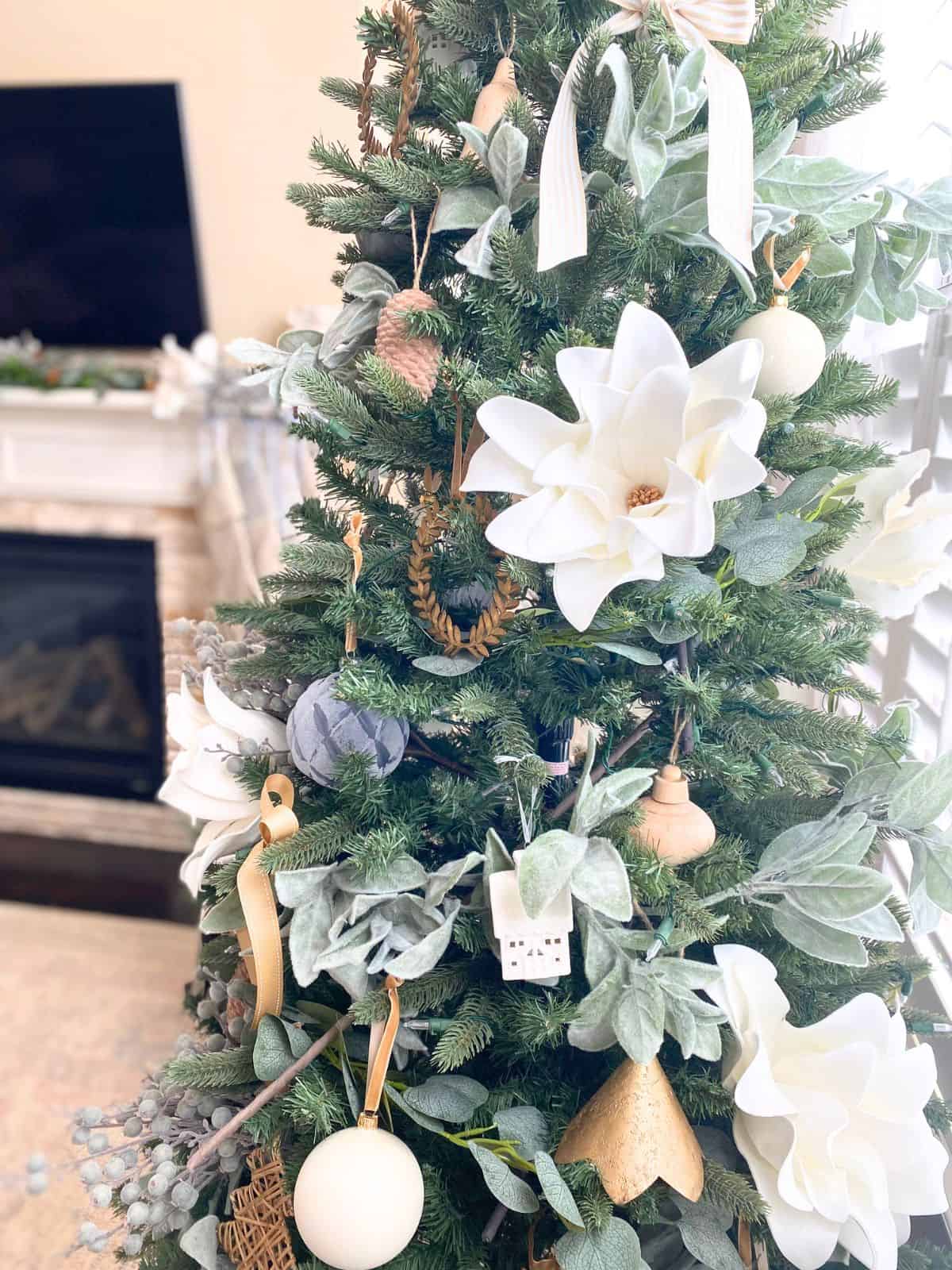 christmas tree decorated in blues, whites, wood, and gold