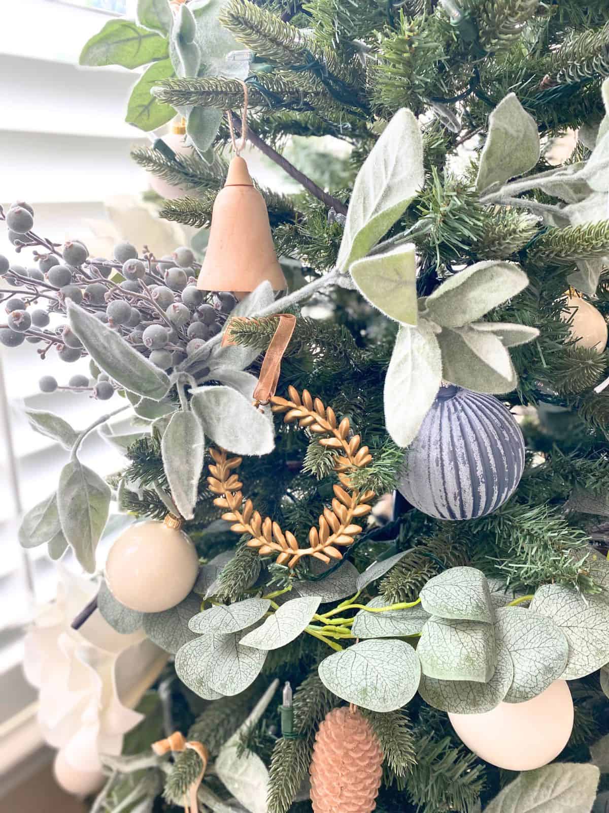 christmas tree decorated in blues, whites, wood, and gold