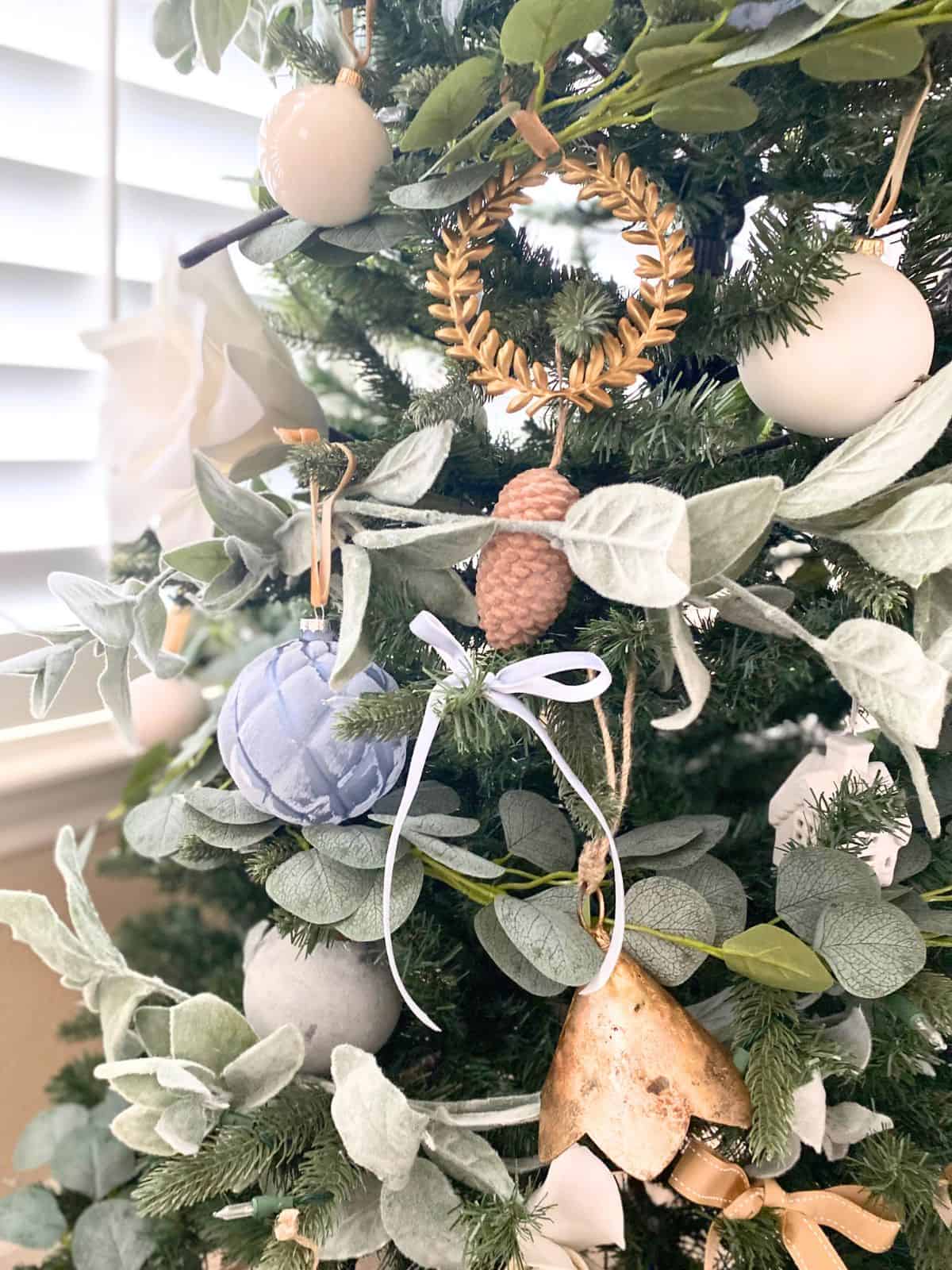 christmas tree decorated in blues, whites, wood, and gold