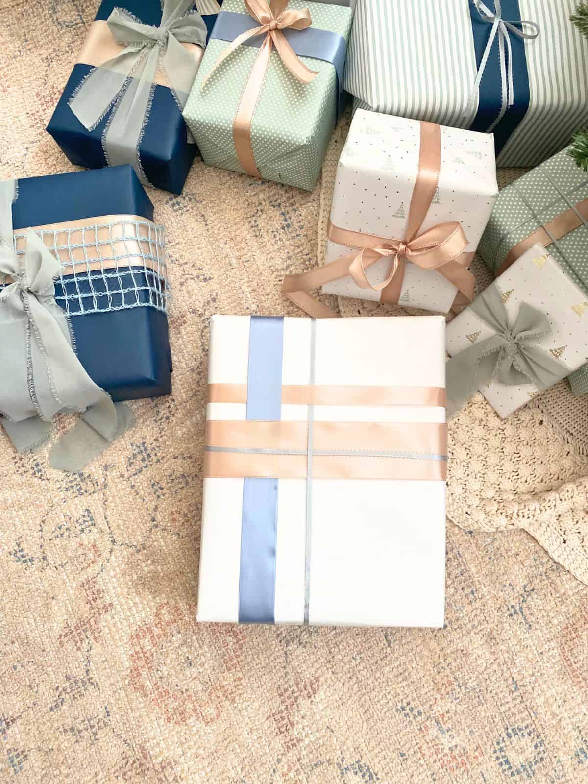 present with white wrapping paper and layers of blue and pink ribbons