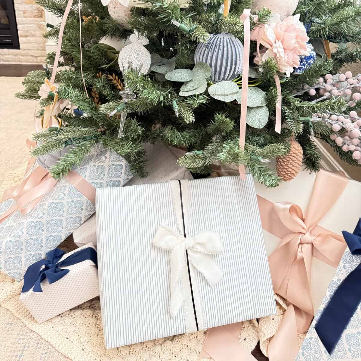 blue striped wrapped present under a christmas tree