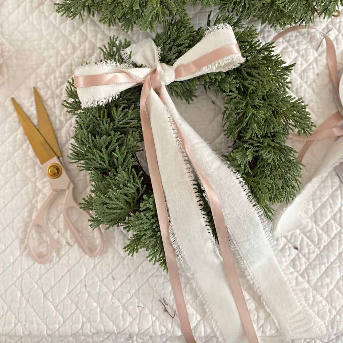 bow of white and blush pink ribbon on mini wreath