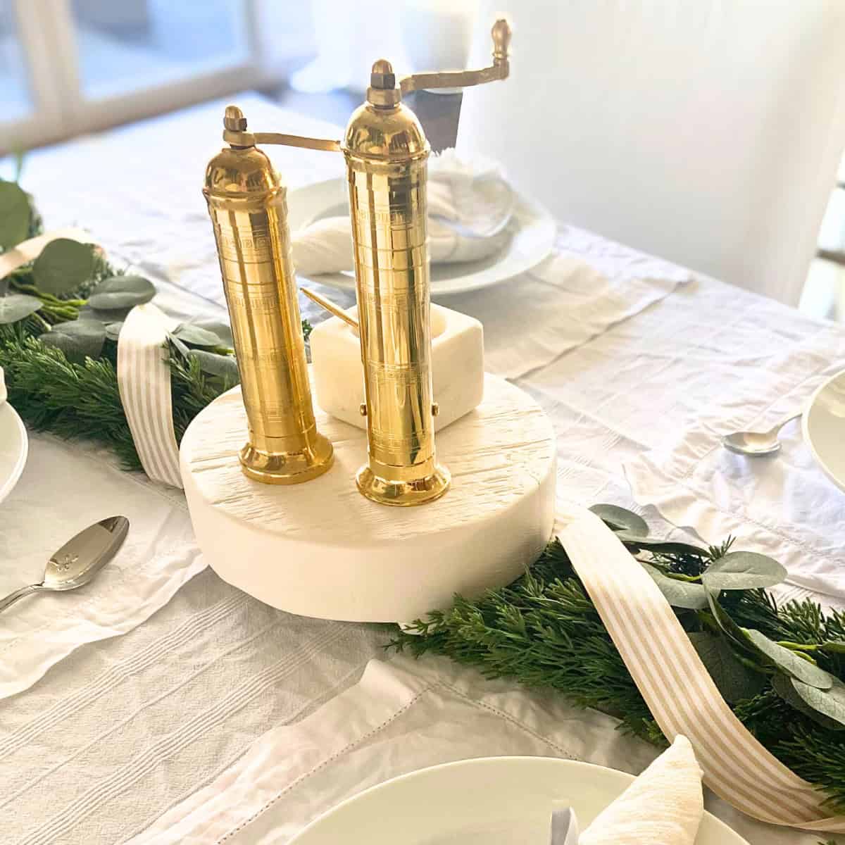 brass salt and pepper mill grinders on tablescape