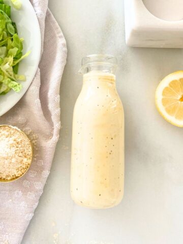 homemade Caesar salad dressing in a glass bottle