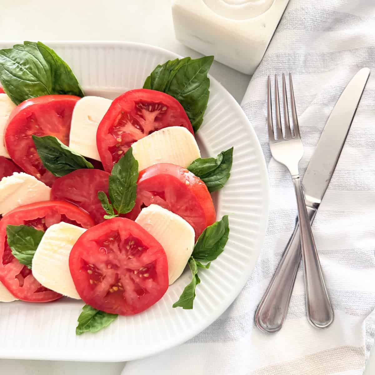 Caprese salad served on a white platter