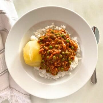 chicken tikka masala served over rice with boiled yellow potato