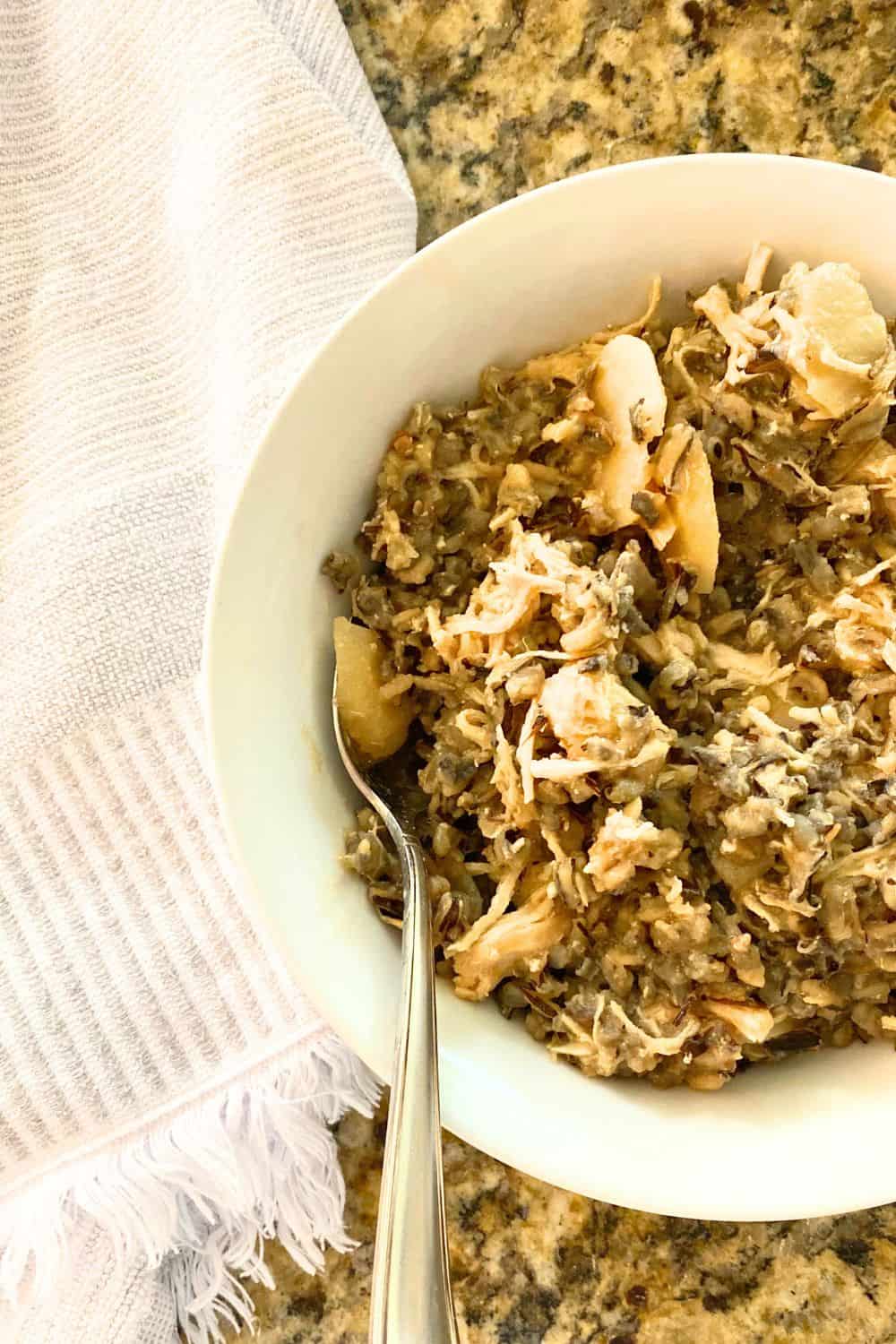 chicken wild rice casserole served in a white bowl with a spoon