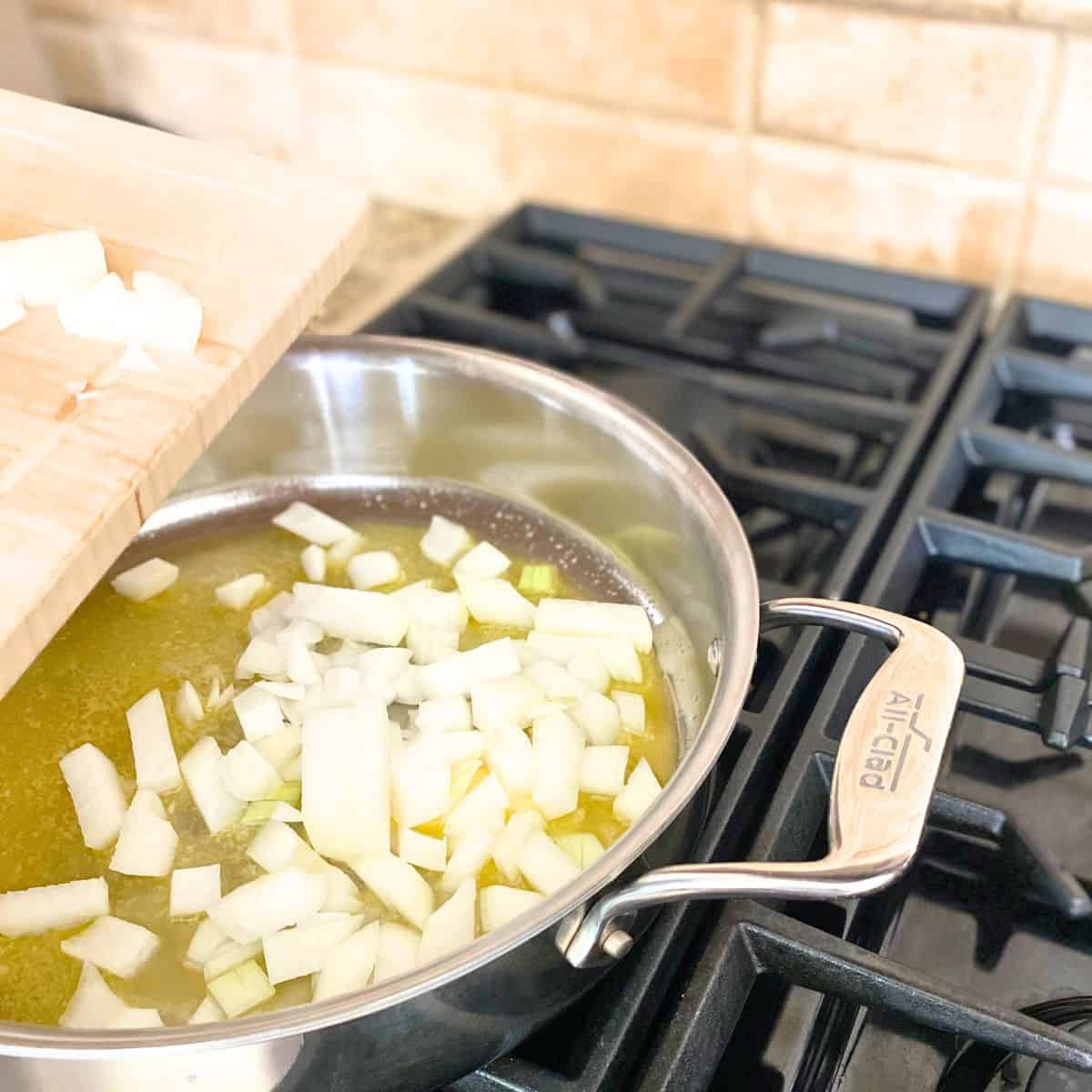 diced onion added to a sauté pan of butter
