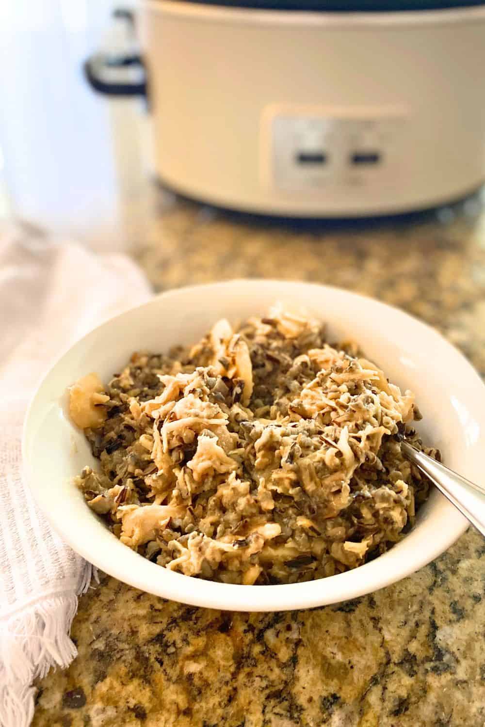 slow cooker chicken wild rice casserole served in a white porcelain bowl