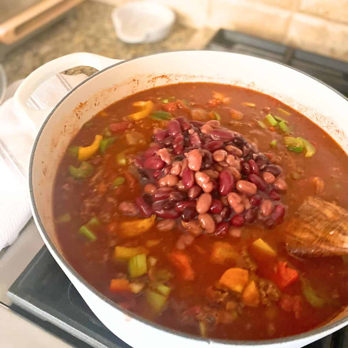 Added beans to chili on stove