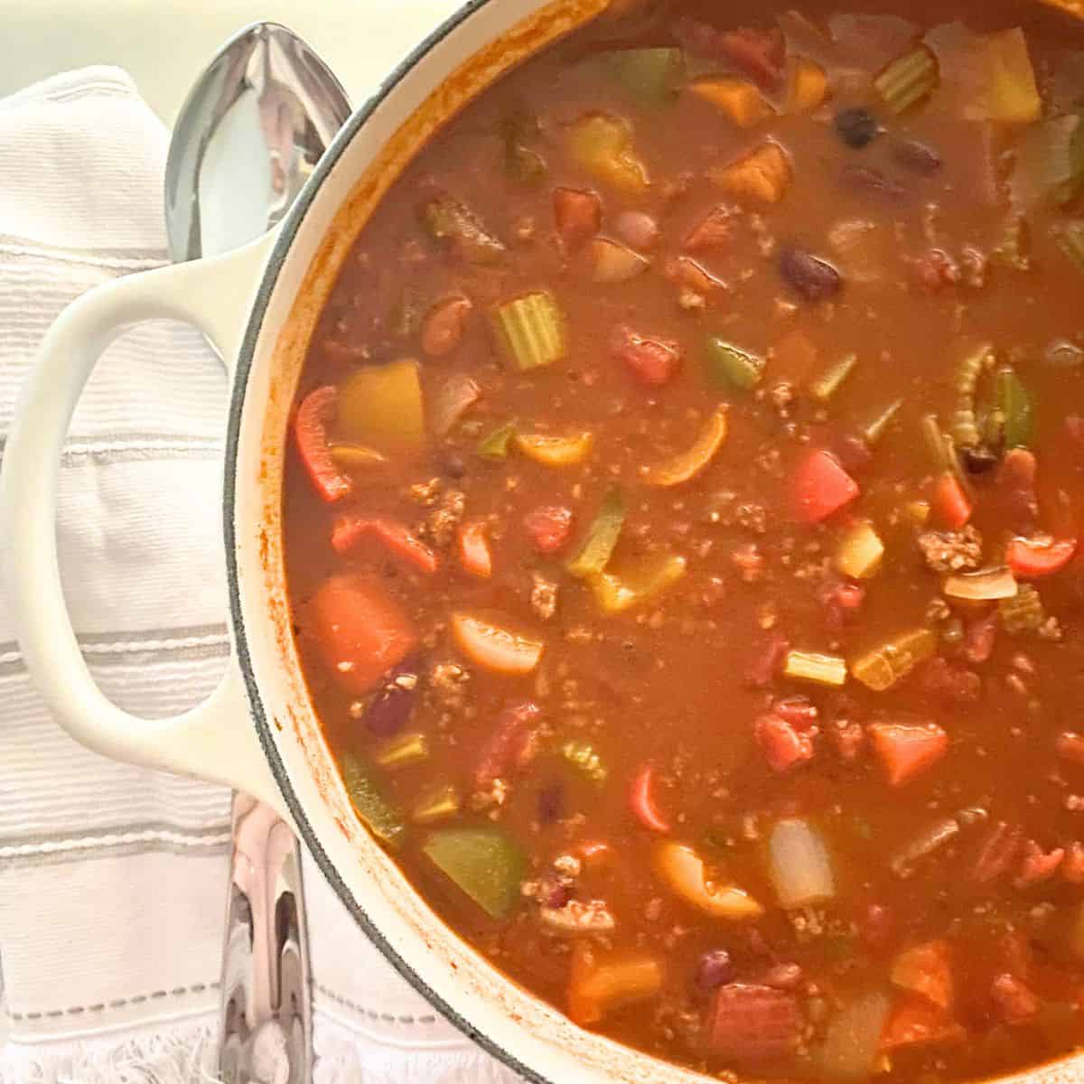 Chili in a large white cast iron pot