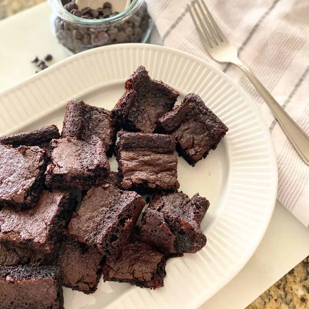 Chocolate chip brownies on a white porcelain serving platter