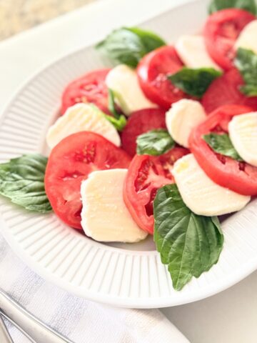 Caprese salad served on a white platter