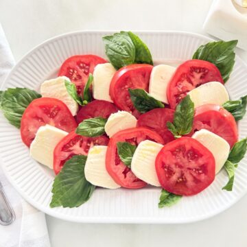 Caprese salad served on a white platter