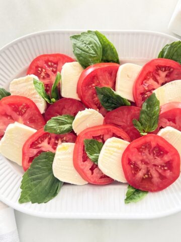 Caprese salad served on a white platter