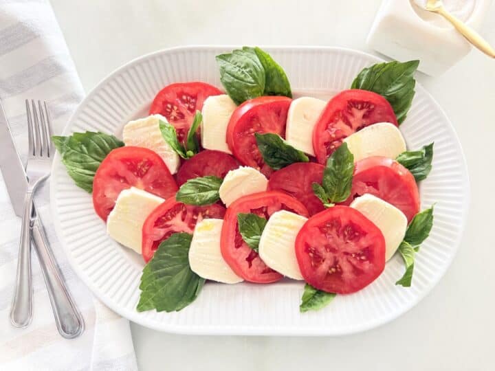 Caprese salad served on a white platter