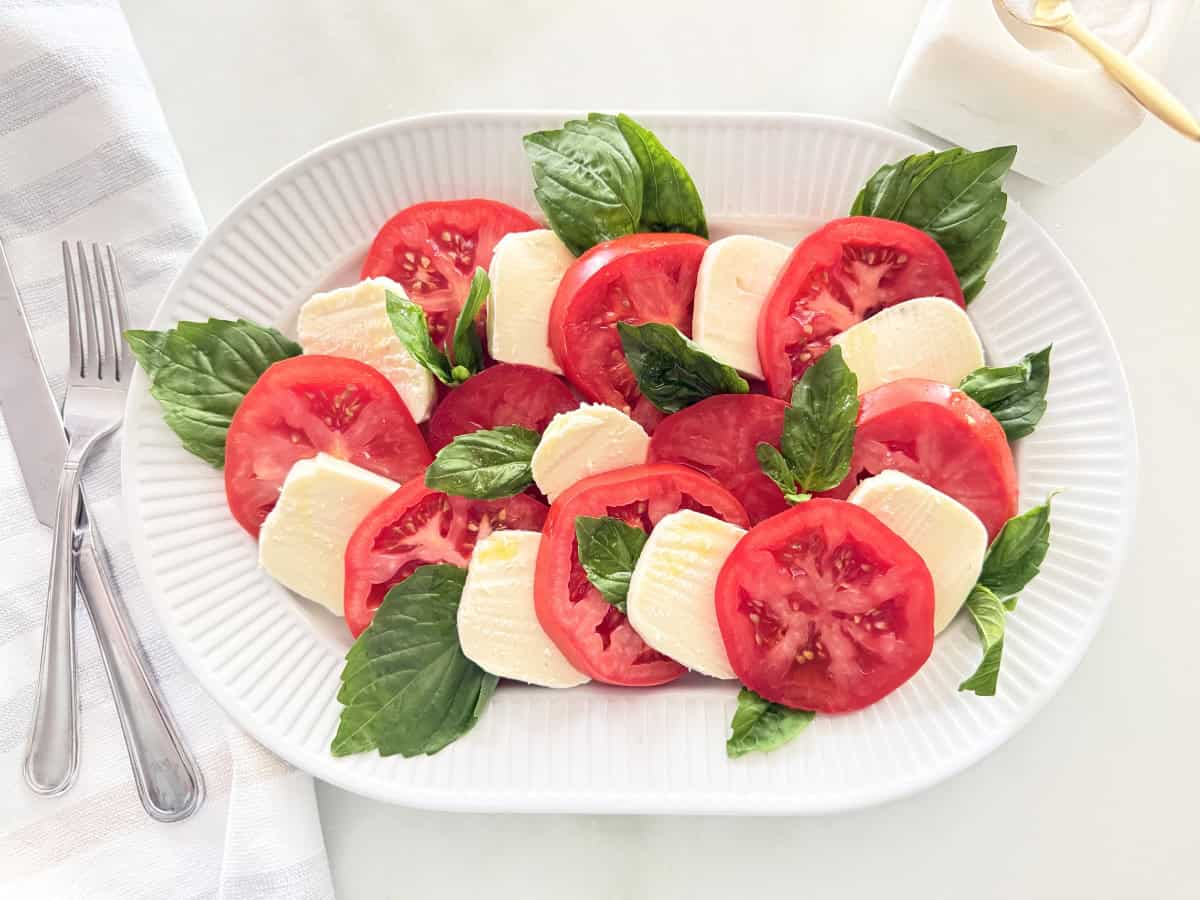 Caprese salad served on a white platter