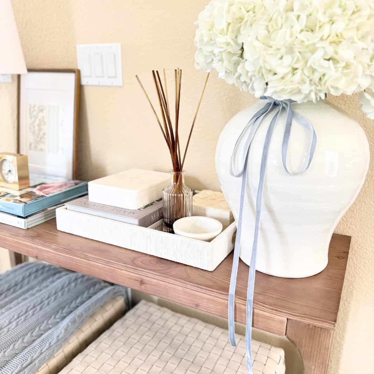 vase and tray with decor styled on an entry table