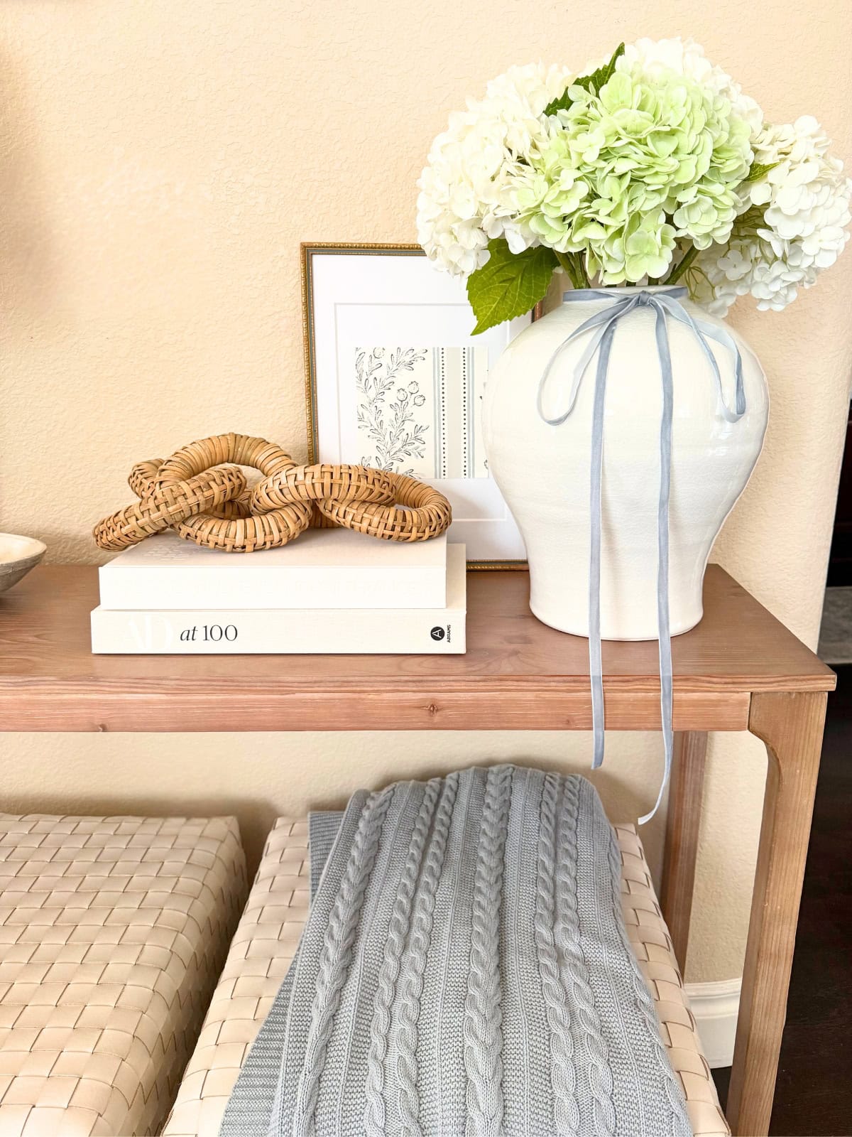 entry console with pretty vase, books and decorations