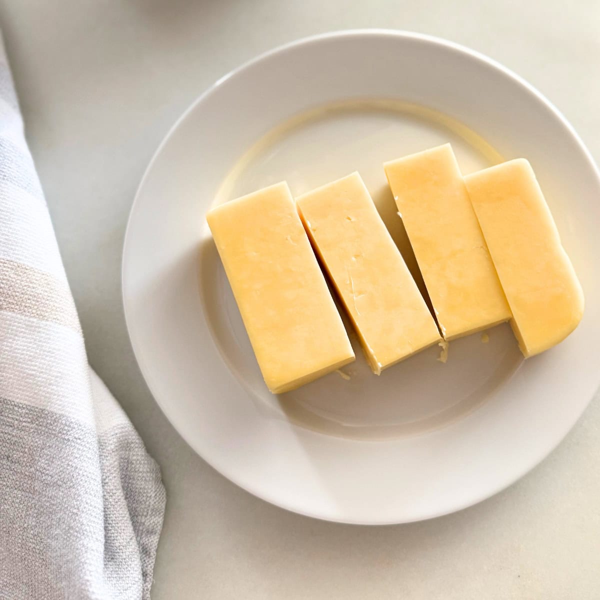 block of cheddar cheese cut into chunks