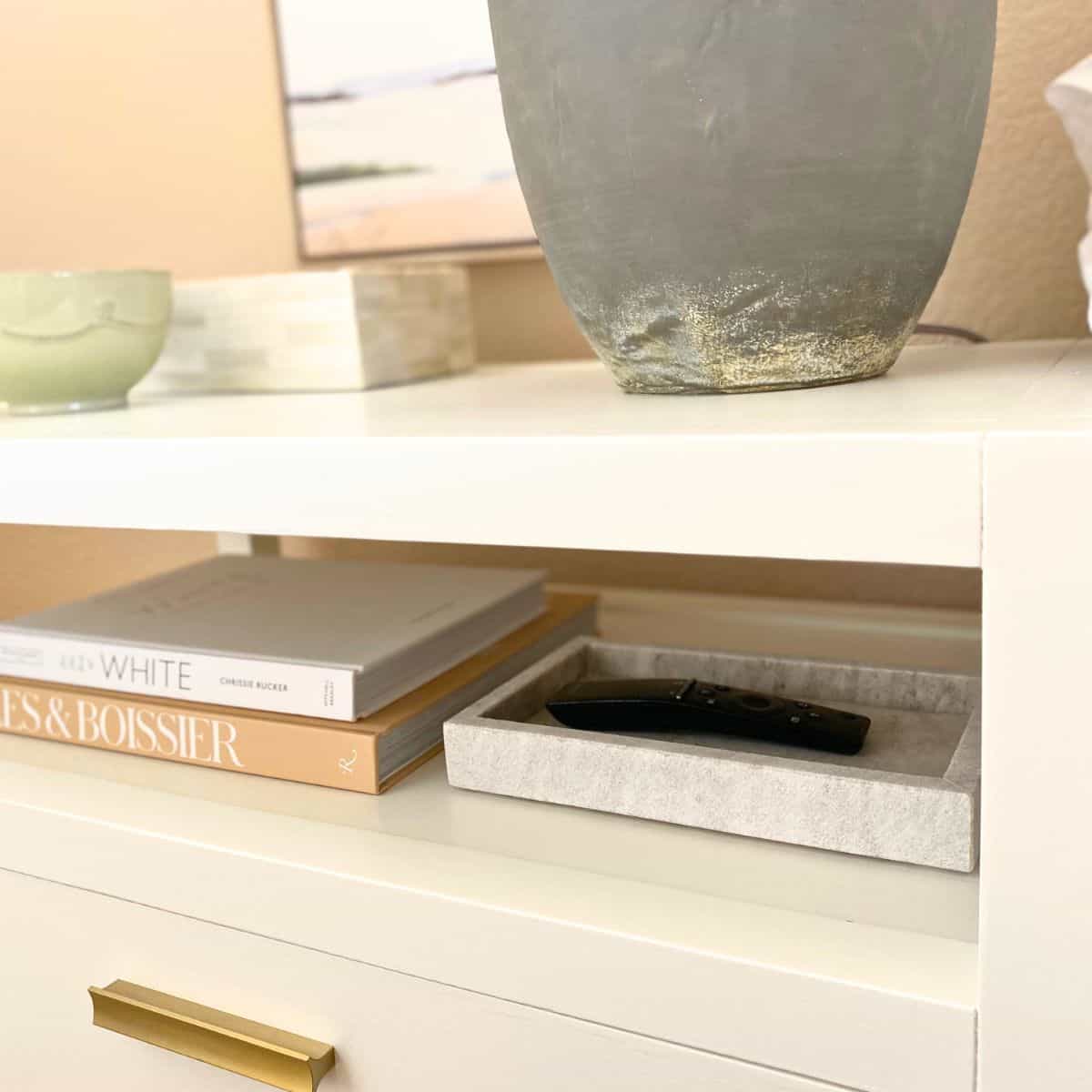 marble tray and stacked books on a bedside table