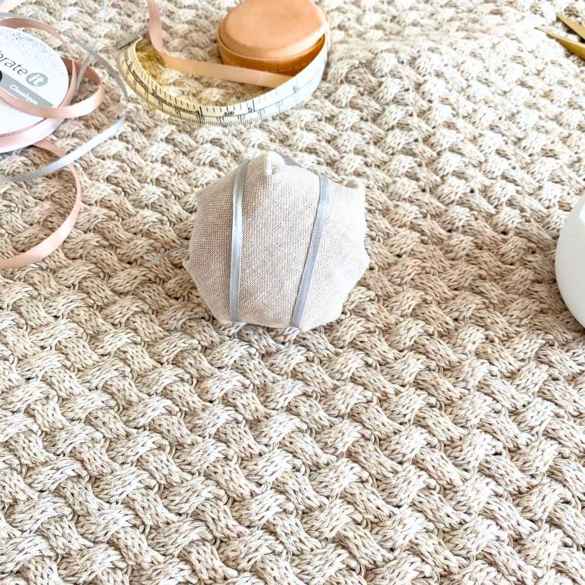 pincushion decorated with blue ribbon