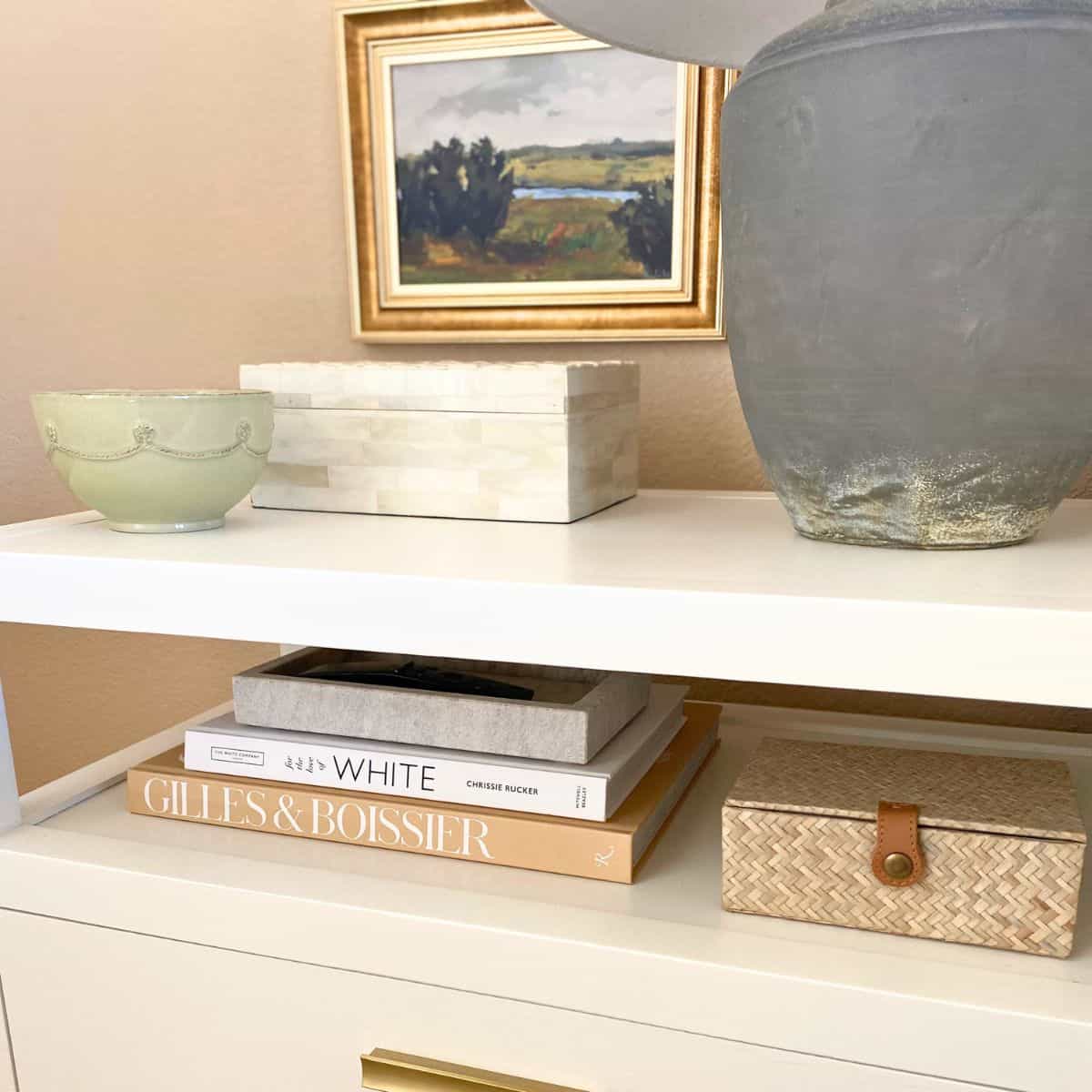 nightstand decorated with stacked books and boxes