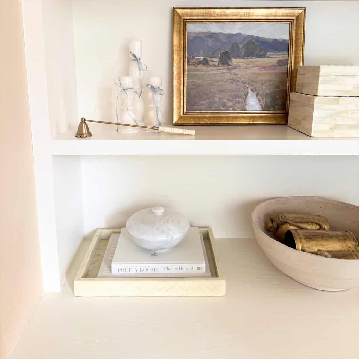 shelves decorated with tray and bowls and art