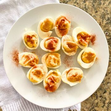 Deviled eggs presented on a white plate