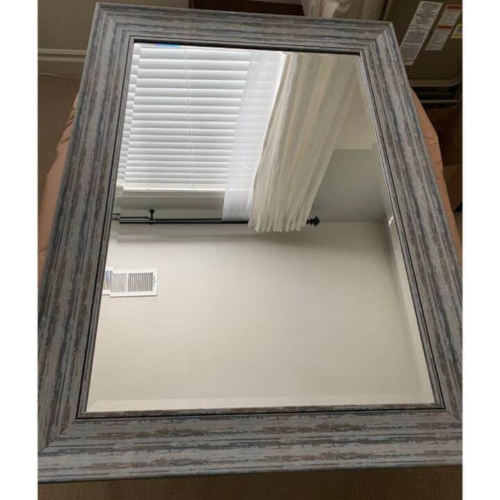 This is the gray-blue framed mirror before the DIY.