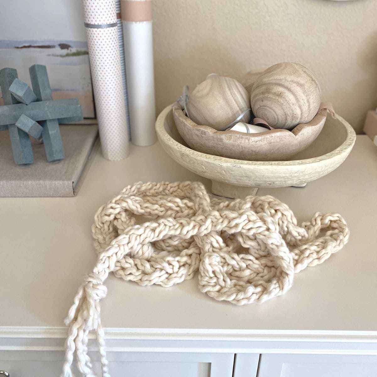 braided yarn garland on top of a white dresser