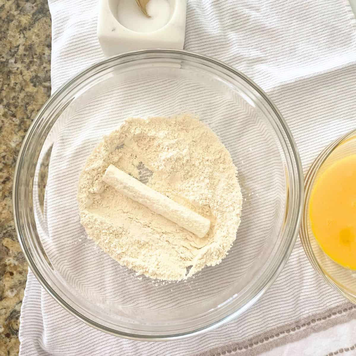 step one is dredge cheese stick on flour