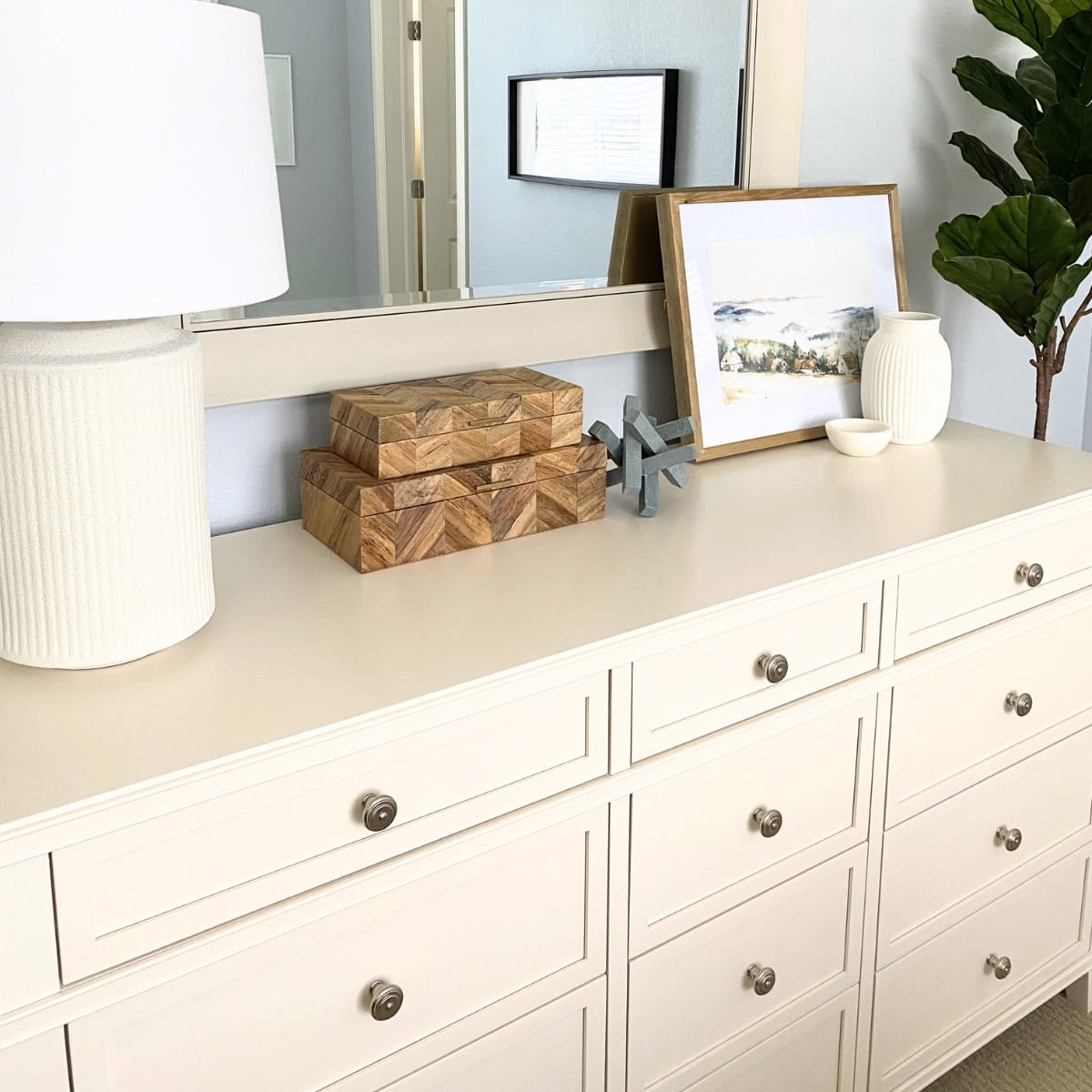 white dresser styled with decor