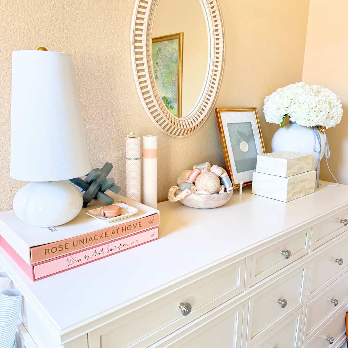 white dresser with decor on top