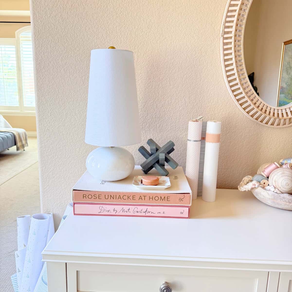 marble lamp stacked on two books atop a dresser