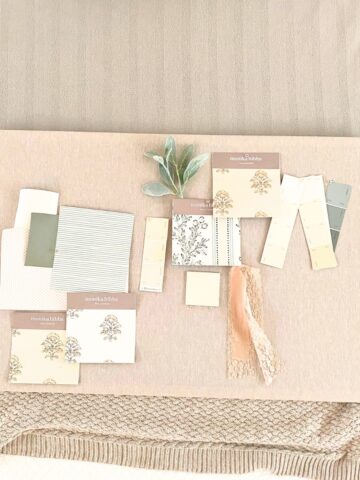diy linen fabric pinboard with wallpaper and paint samples pinned to it