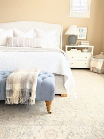 upholstered bed frame in styled bedroom