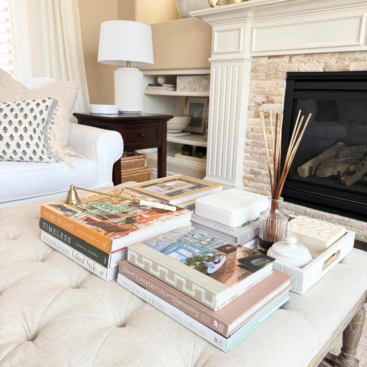 coffee table stacked with books in fall colors