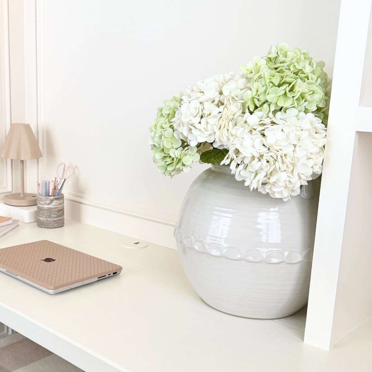 faux white hydrangeas in large vase