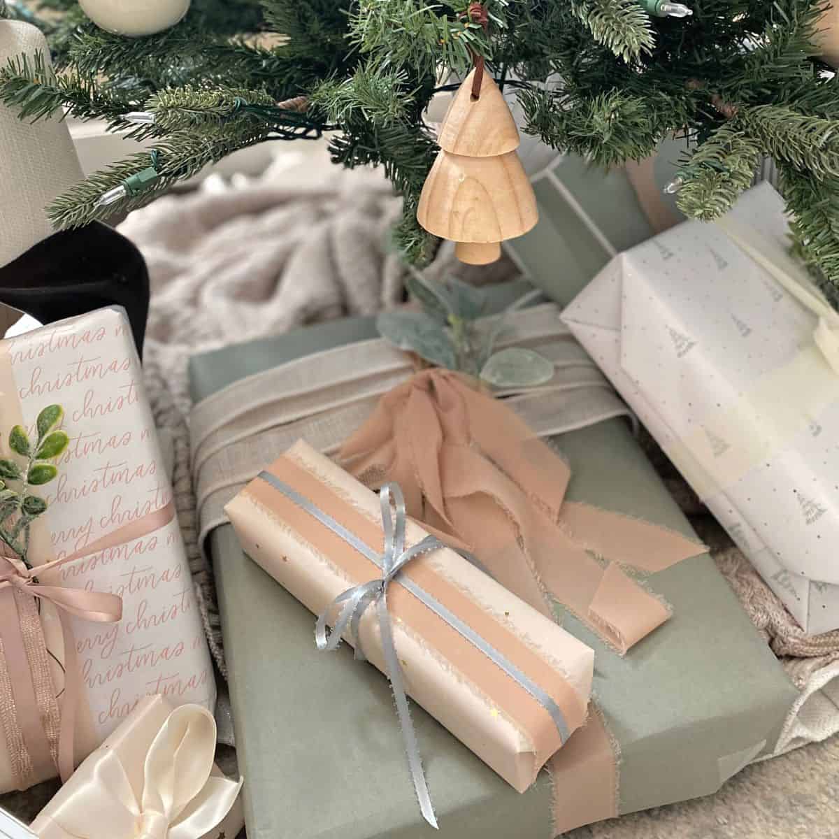 presents wrapped in pastel paper under a tree