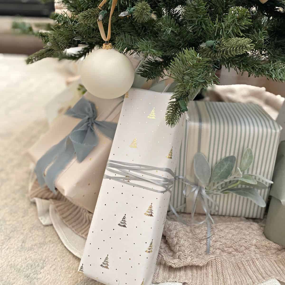presents wrapped in pastel paper under a tree