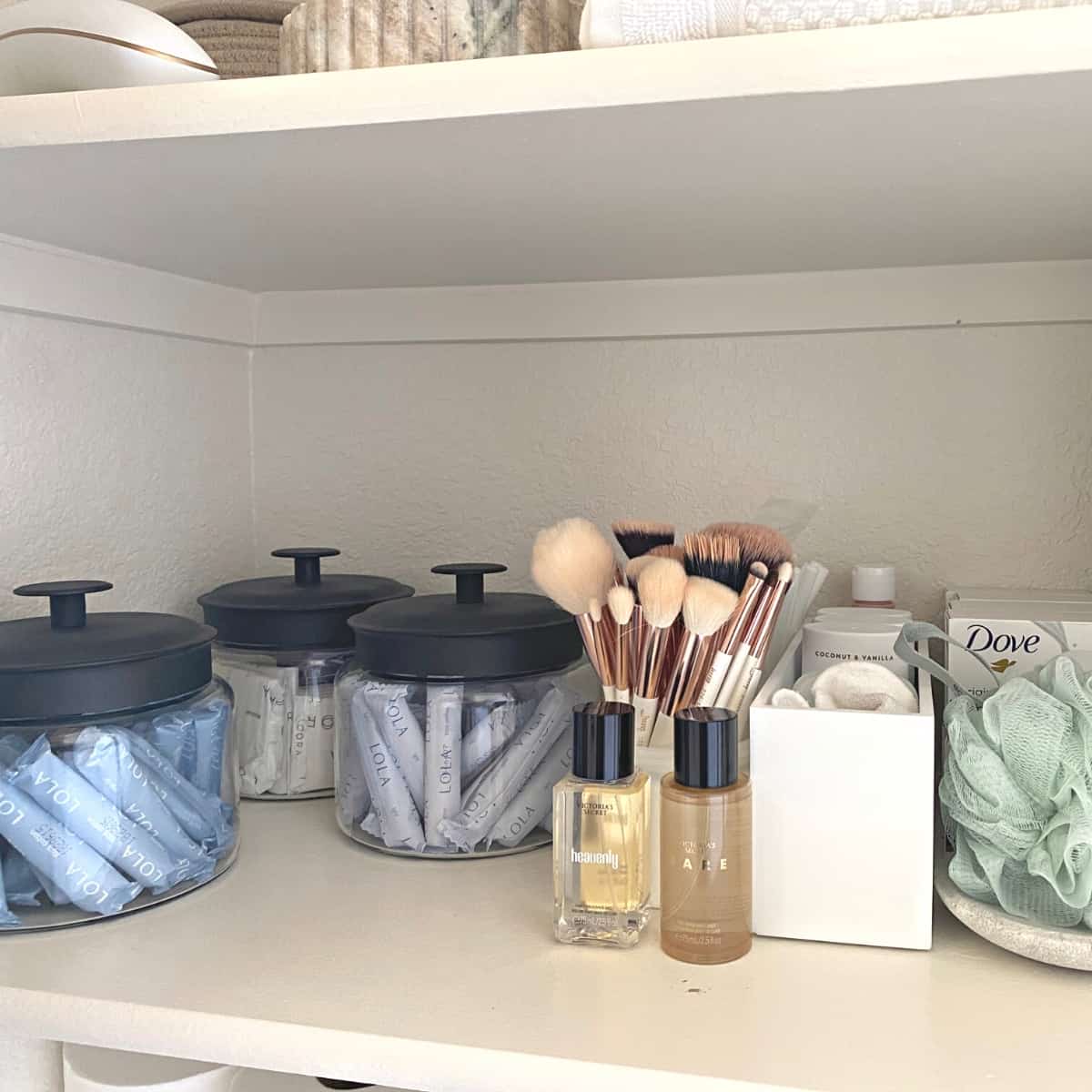 Glass canisters and bathroom toiletries organized in a closet